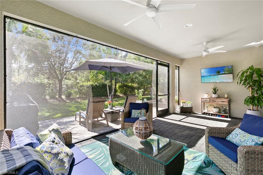 14796 Windward Lane Naples, FL 34114 - Photo 29 of 50 a living room with furniture and a large window