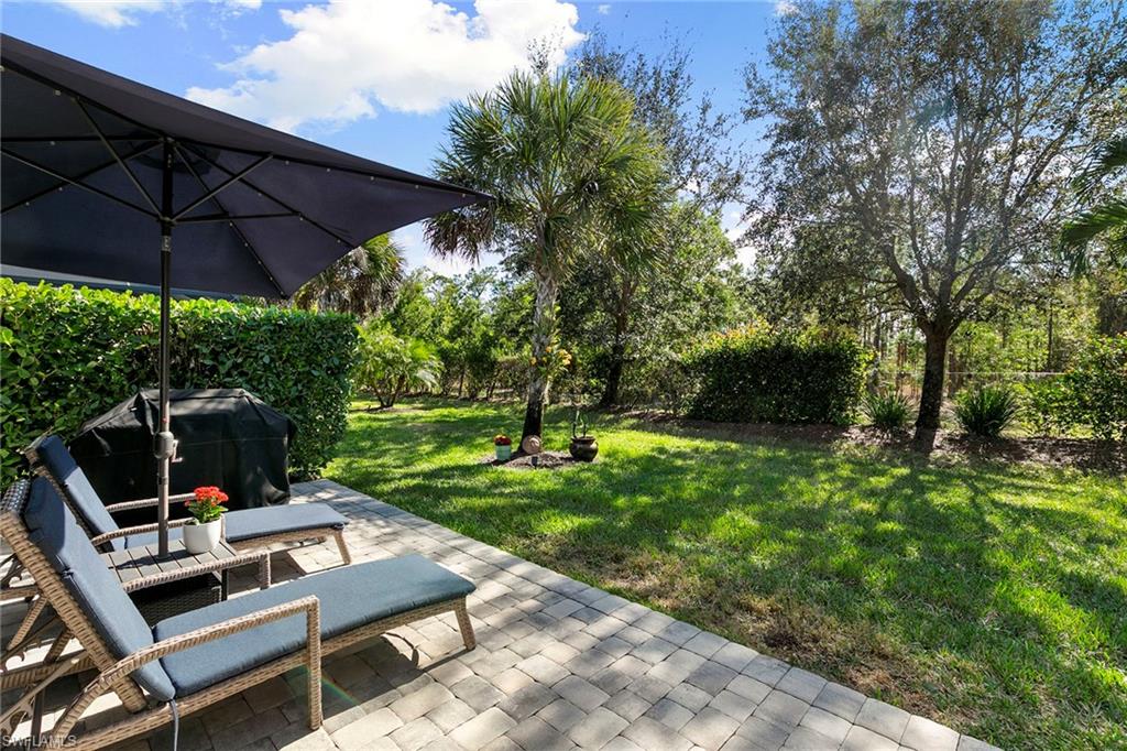 14796 Windward Lane Naples, FL 34114 - Photo 31 of 50 a view of a backyard with sitting area