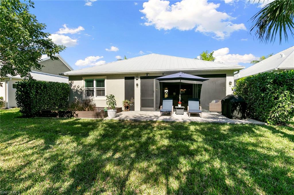 14796 Windward Lane Naples, FL 34114 - Photo 33 of 50 a view of a house with backyard porch and sitting area