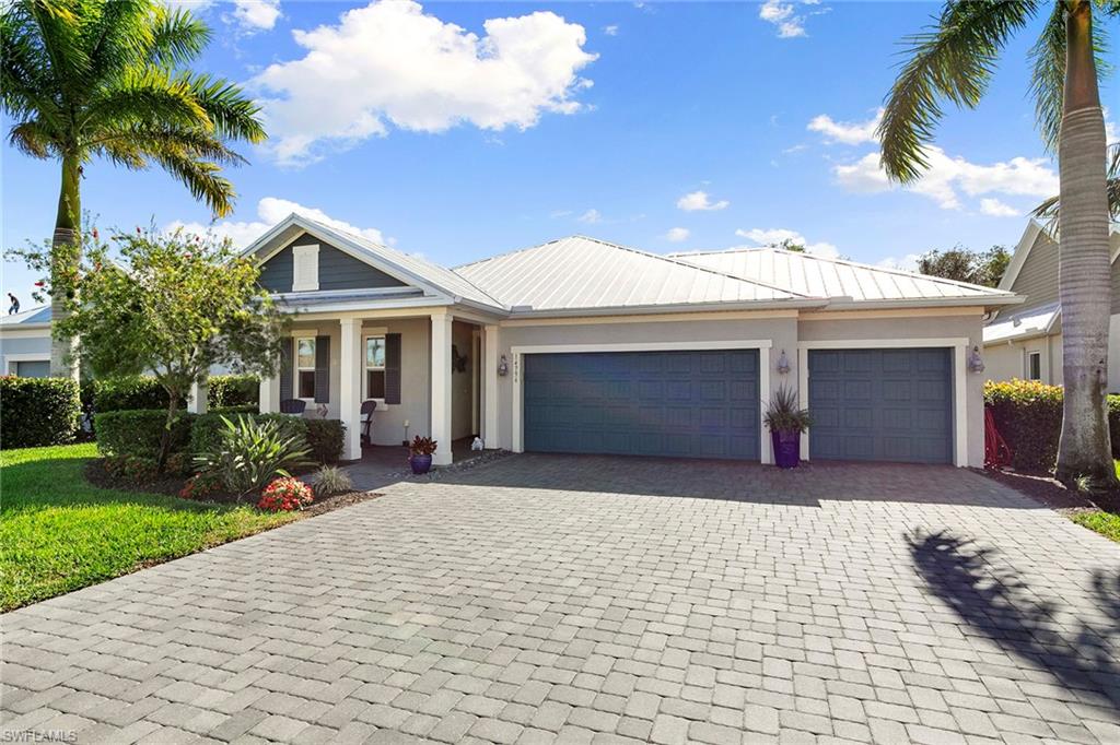 14796 Windward Lane Naples, FL 34114 - Photo 39 of 50 a front view of a house with a yard and garage