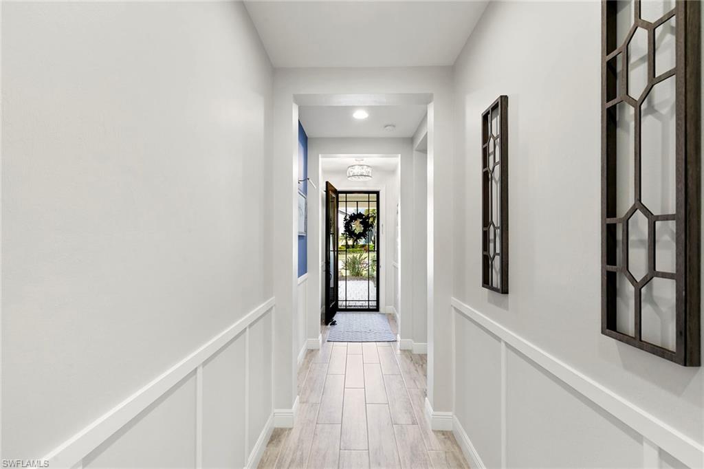 14796 Windward Lane Naples, FL 34114 - Photo 4 of 50 a view of a hallway with wooden floor and staircase