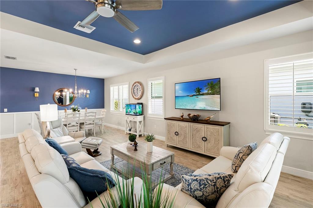 14796 Windward Lane Naples, FL 34114 - Photo 8 of 50 a living room with furniture and a flat screen tv