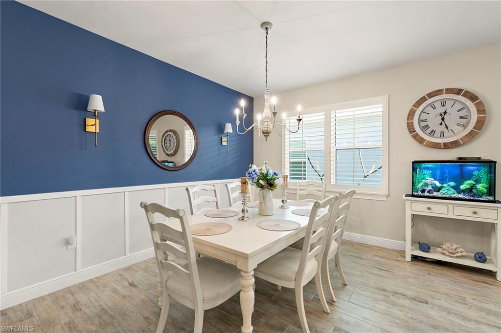 14796 Windward Lane Naples, FL 34114 - Photo 10 of 50 a view of a dining room with furniture a rug and wooden floor
