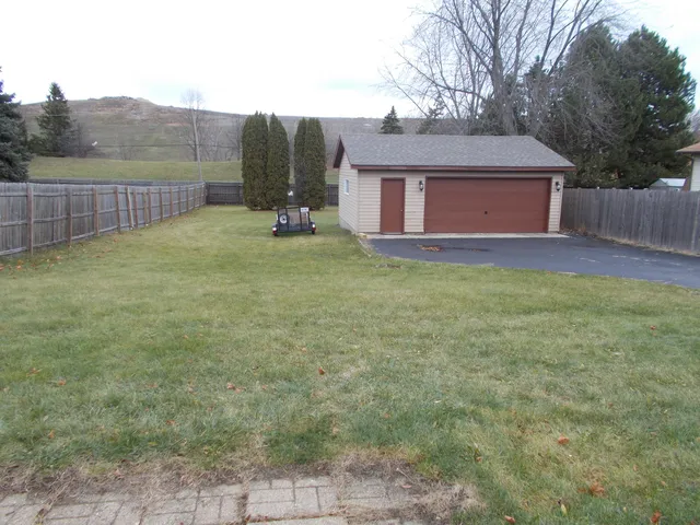 a view of a house with a backyard