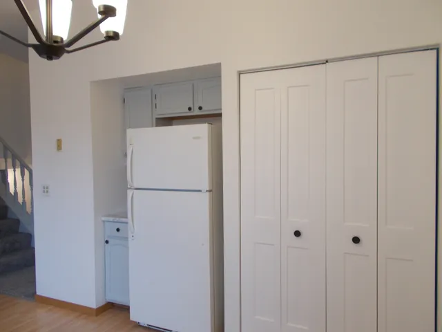 a white refrigerator freezer sitting in a kitchen