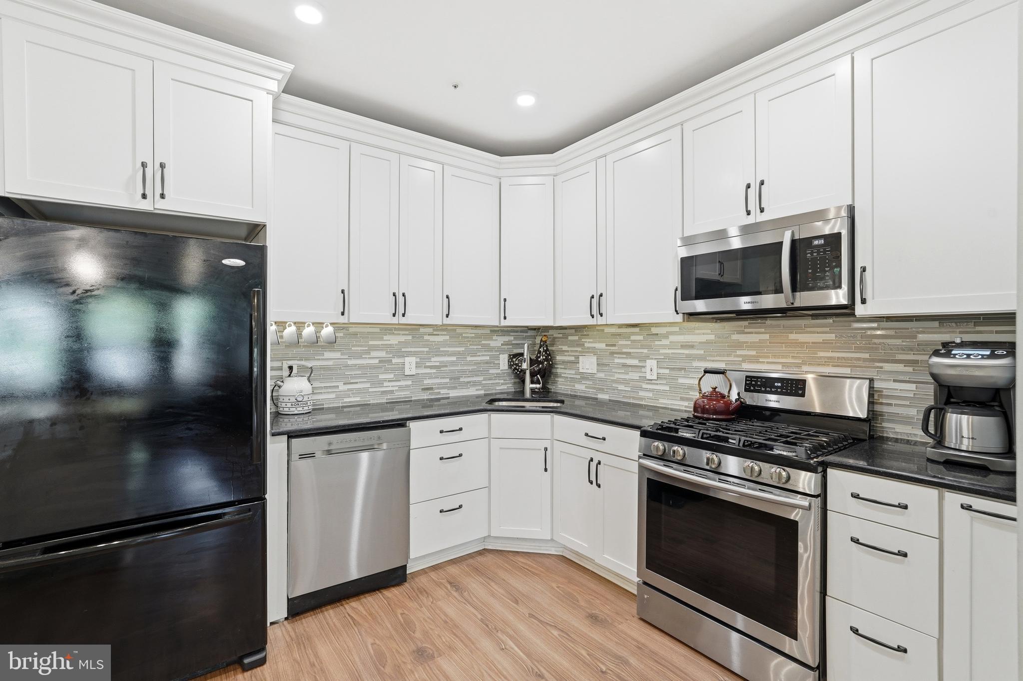 13513 Giant Court Germantown, MD 20874 - Photo 15 of 37 a kitchen with granite countertop white cabinets and stainless steel appliances