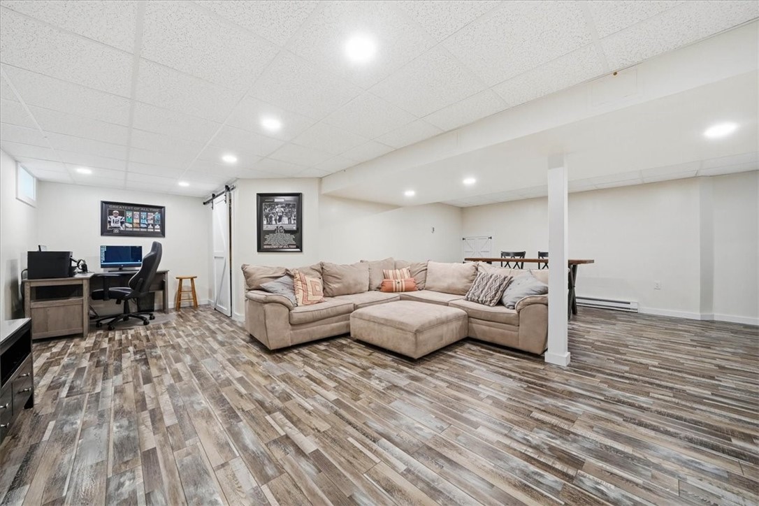 26 Davis Circle Warwick, RI 02886 - Photo 36 of 50 The expansive finished basement offers exceptional flexibility with room for a media area, game room, home gym, play space, or additional family room.