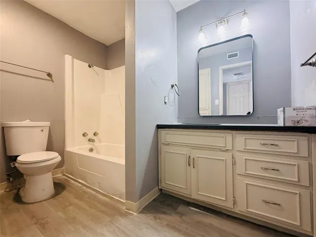a bathroom with a toilet a sink and a bathtub