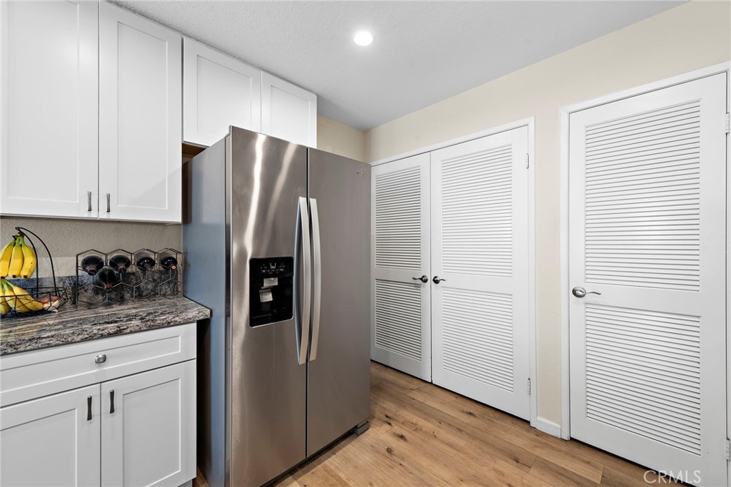 22 Exeter, Unit 23 Irvine, CA 92612 - Photo 16 of 30 a kitchen with stainless steel appliances granite countertop a refrigerator and a stove