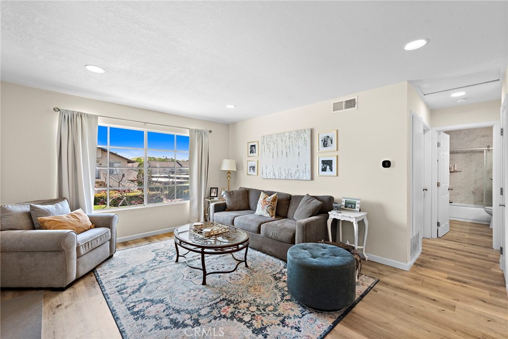 22 Exeter, Unit 23 Irvine, CA 92612 - Photo 4 of 30 a living room with furniture and a large window