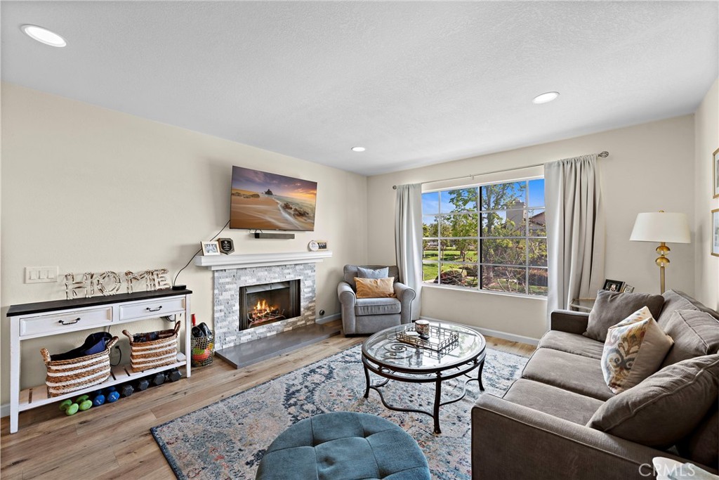 22 Exeter, Unit 23 Irvine, CA 92612 - Photo 6 of 30 a living room with furniture and a fireplace