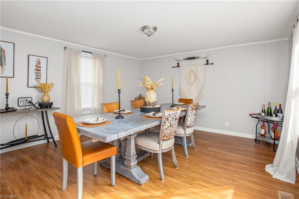 4770 New Walkertown Road Walkertown, NC 27051 - Photo 9 of 34 bedroom 3 currently staged with a dining room set for storage purposes