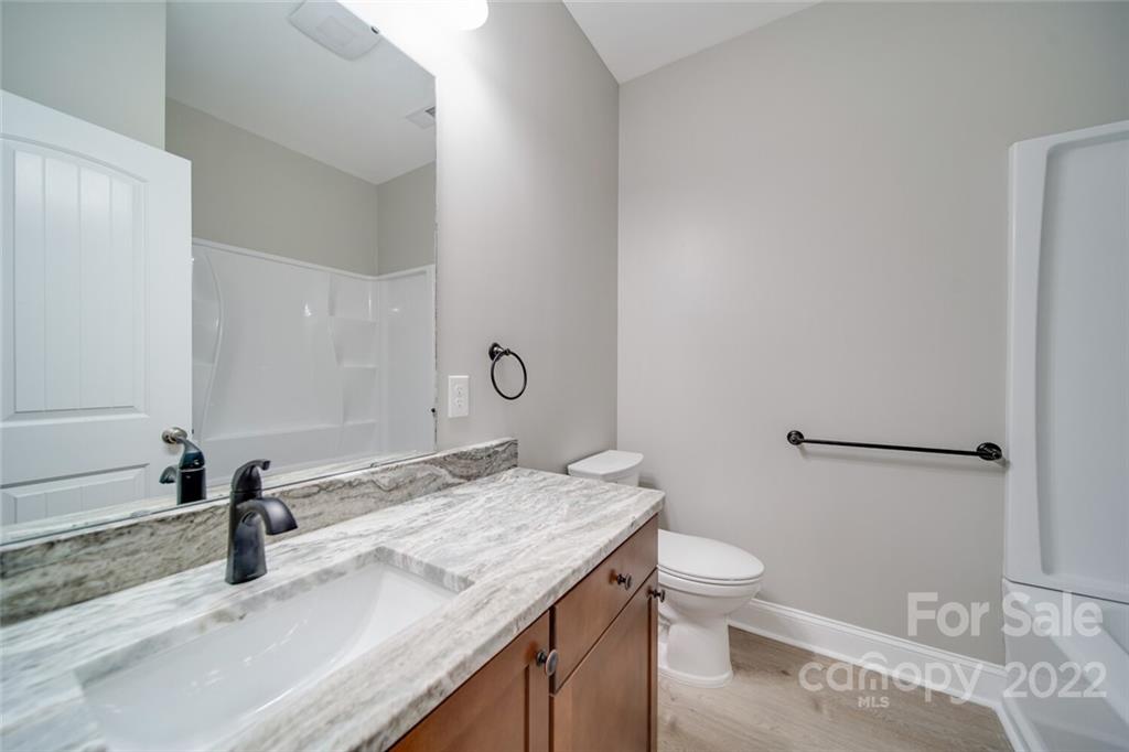 148 1st Street South Fort Mill, SC 29708 - Photo 24 of 48 a bathroom with a granite countertop sink a toilet and a mirror