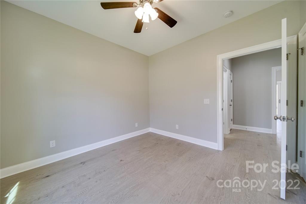 148 1st Street South Fort Mill, SC 29708 - Photo 25 of 48 an empty room with a chandelier fan and closet area
