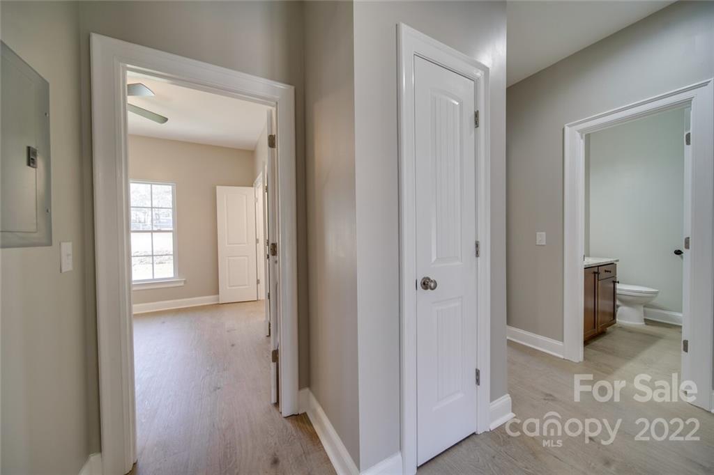148 1st Street South Fort Mill, SC 29708 - Photo 28 of 48 a view of a hallway with wooden floor and a bathroom