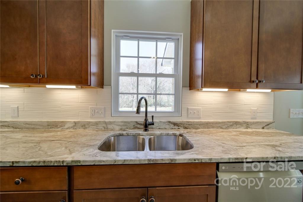 148 1st Street South Fort Mill, SC 29708 - Photo 36 of 48 a kitchen with granite countertop a sink and a window
