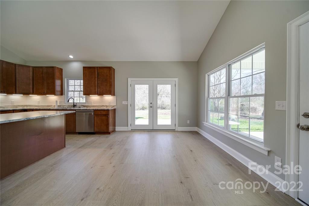 148 1st Street South Fort Mill, SC 29708 - Photo 44 of 48 a kitchen with stainless steel appliances granite countertop a stove a sink dishwasher and a large window