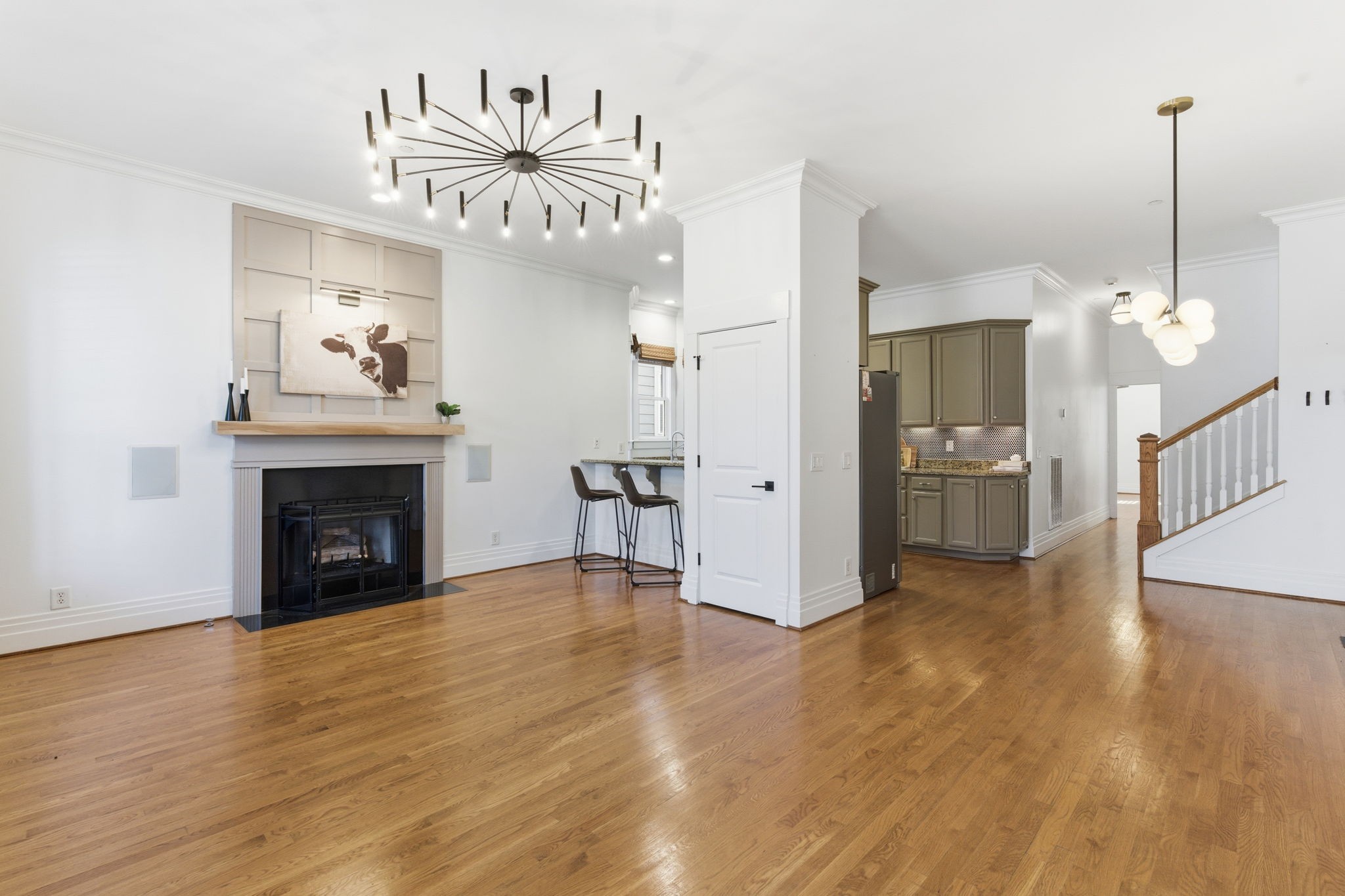 a view of a livingroom with a fireplace a chandelier and wooden floor