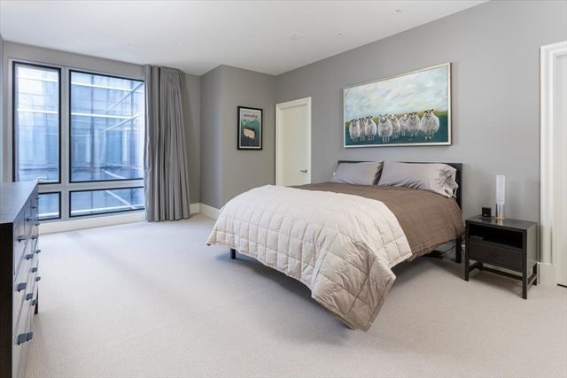 a bed sitting in a bedroom next to a window