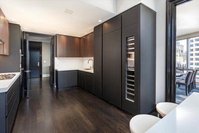 a kitchen with stainless steel appliances wooden cabinets and a refrigerator