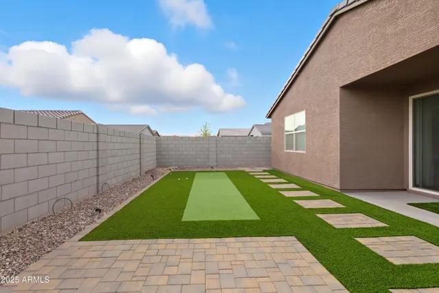 a view of a backyard with sitting area