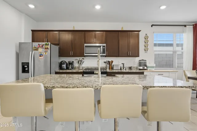 a kitchen with stainless steel appliances granite countertop a sink and cabinets