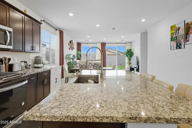 a kitchen with stainless steel appliances granite countertop a sink stove and cabinets