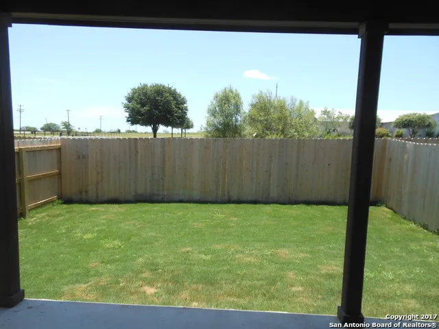 a view of a garden with wooden fence