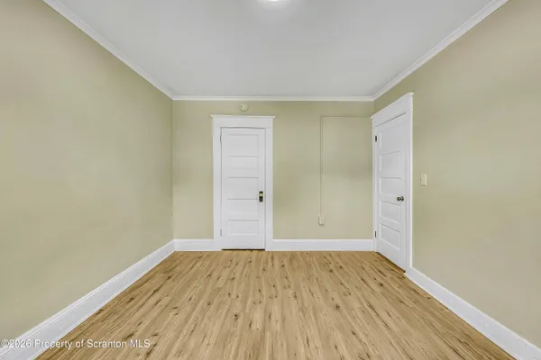 a view of a room with wooden floor