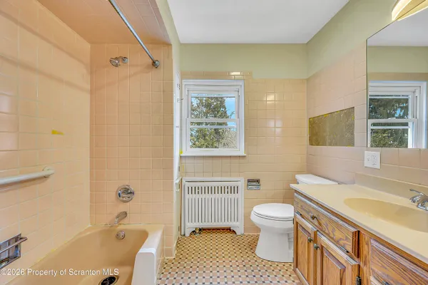 a bathroom with a sink toilet tub and shower