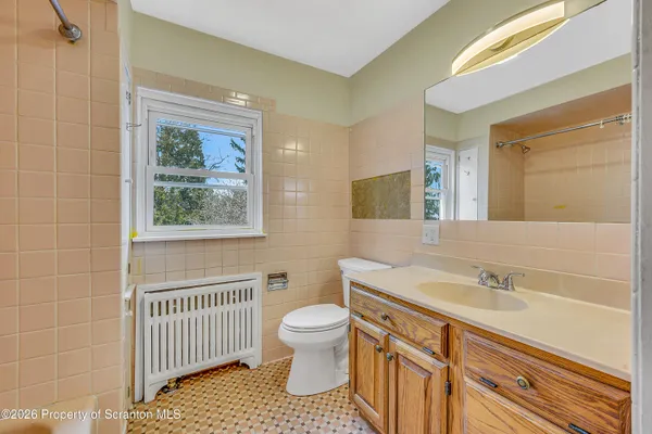 a bathroom with a sink a toilet and a mirror