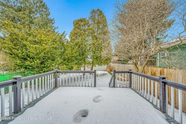 a view of a balcony with wooden fence