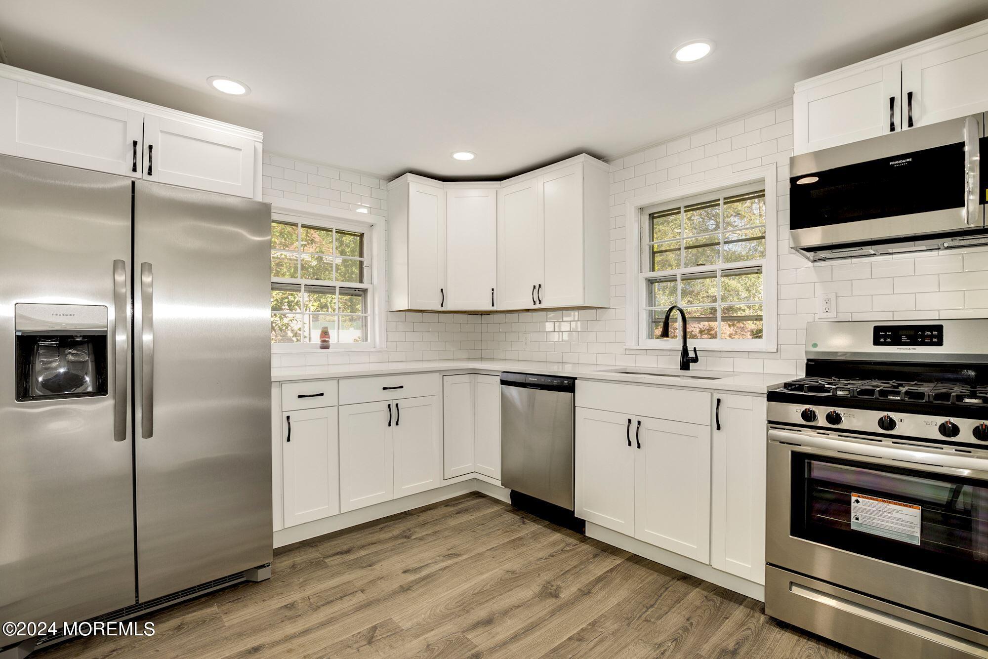 198 Newman Springs Road Red Bank, NJ 07701 - Photo 1 of 13 a kitchen with cabinets stainless steel appliances and wooden floor