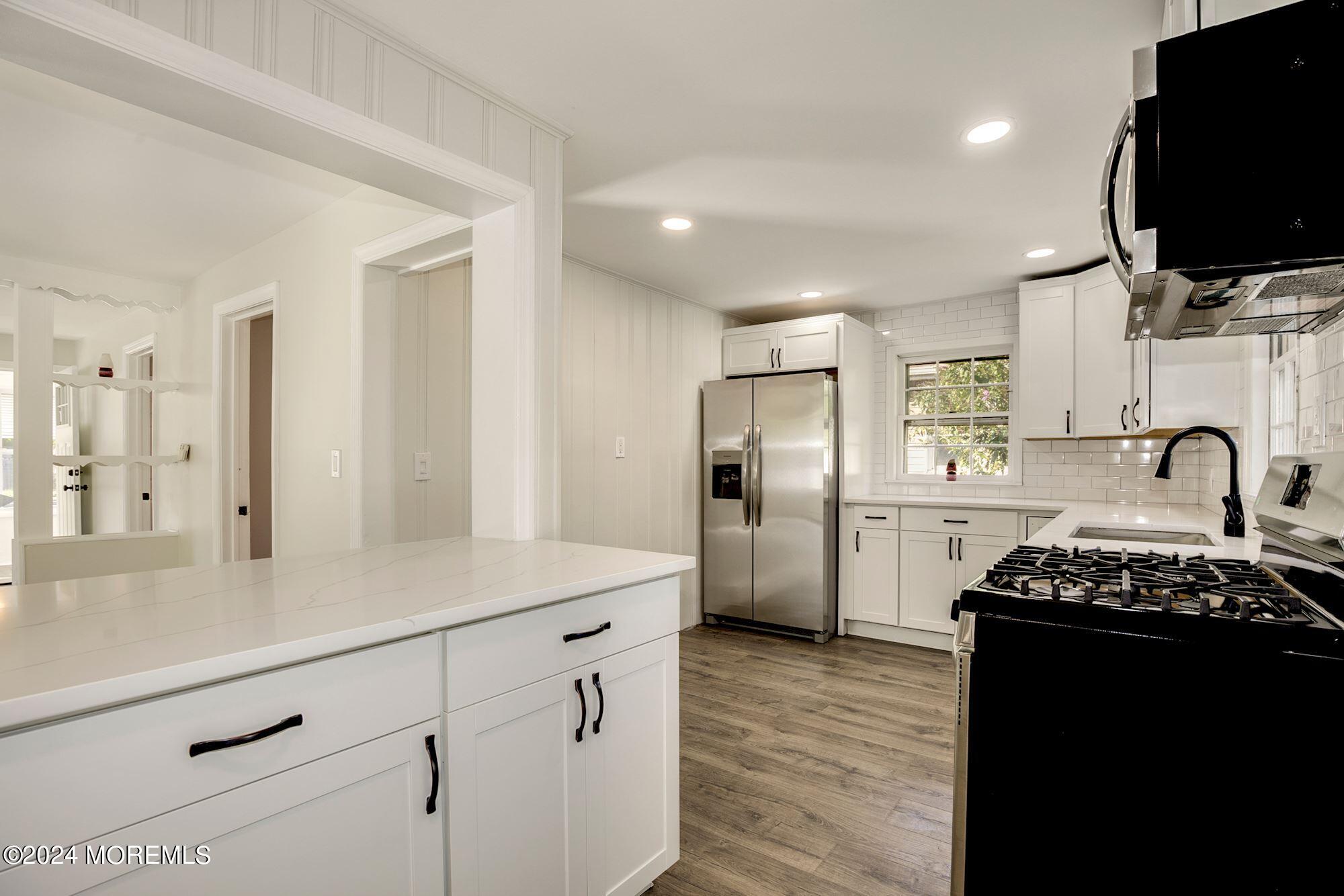 198 Newman Springs Road Red Bank, NJ 07701 - Photo 2 of 13 a kitchen with stainless steel appliances kitchen island a refrigerator and a stove top oven