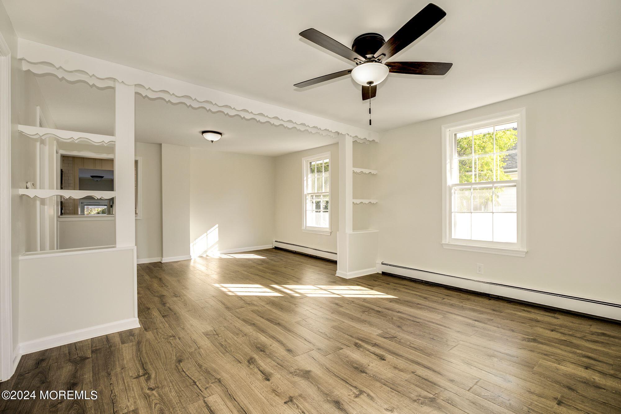 198 Newman Springs Road Red Bank, NJ 07701 - Photo 4 of 13 a view of an empty room with window and wooden floor
