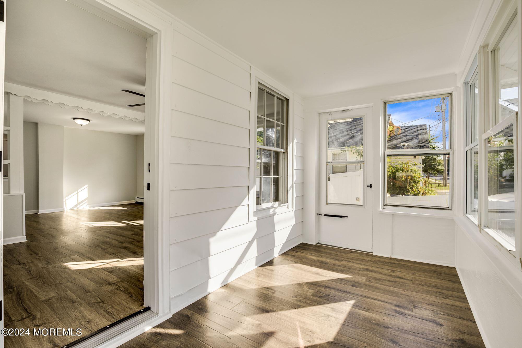 198 Newman Springs Road Red Bank, NJ 07701 - Photo 7 of 13 a view of a hallway with wooden floor and windows