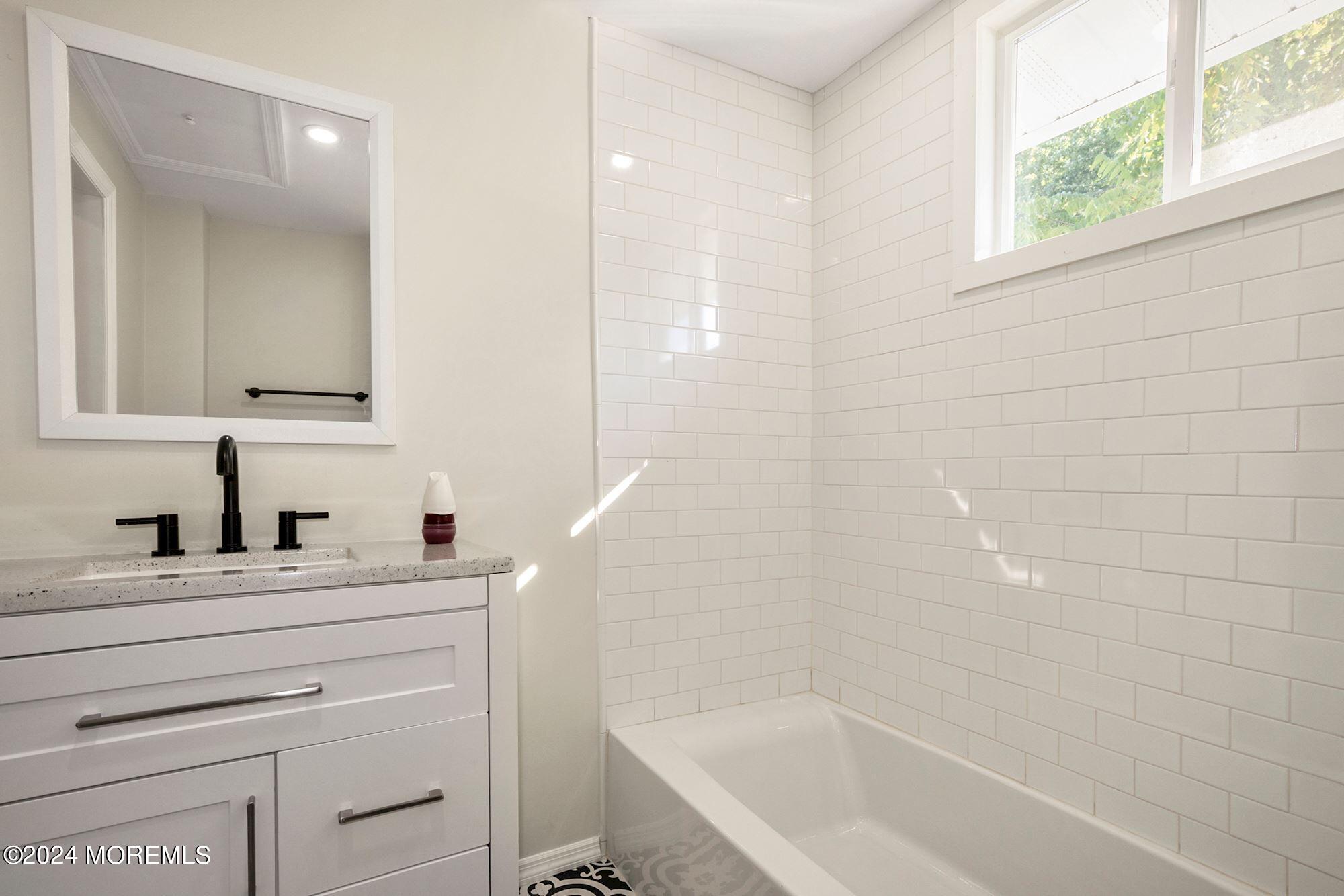 198 Newman Springs Road Red Bank, NJ 07701 - Photo 10 of 13 a bathroom with a bathtub sink vanity and a mirror