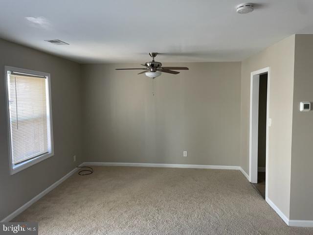17439 Hughes Road Poolesville, MD 20837 - Photo 13 of 25 a view of a room with a ceiling fan and a window