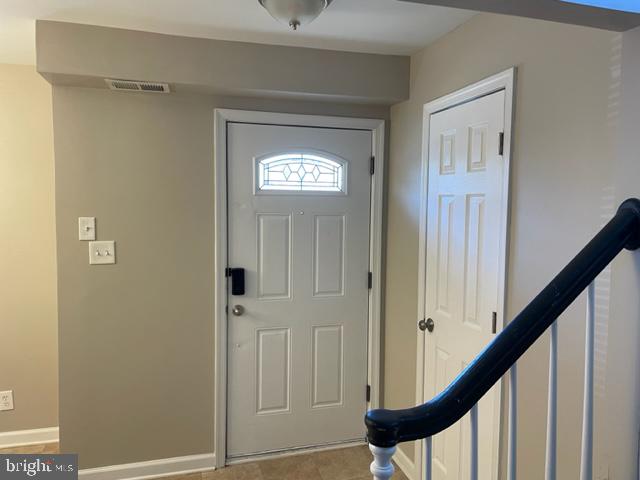17439 Hughes Road Poolesville, MD 20837 - Photo 2 of 25 a view of a hallway with wooden floor and stairs