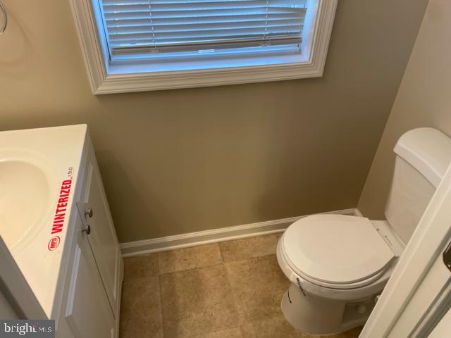 17439 Hughes Road Poolesville, MD 20837 - Photo 4 of 25 a white toilet sitting next to a white cabinet