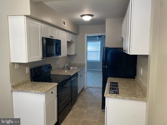 17439 Hughes Road Poolesville, MD 20837 - Photo 7 of 25 a kitchen with a sink a stove and refrigerator