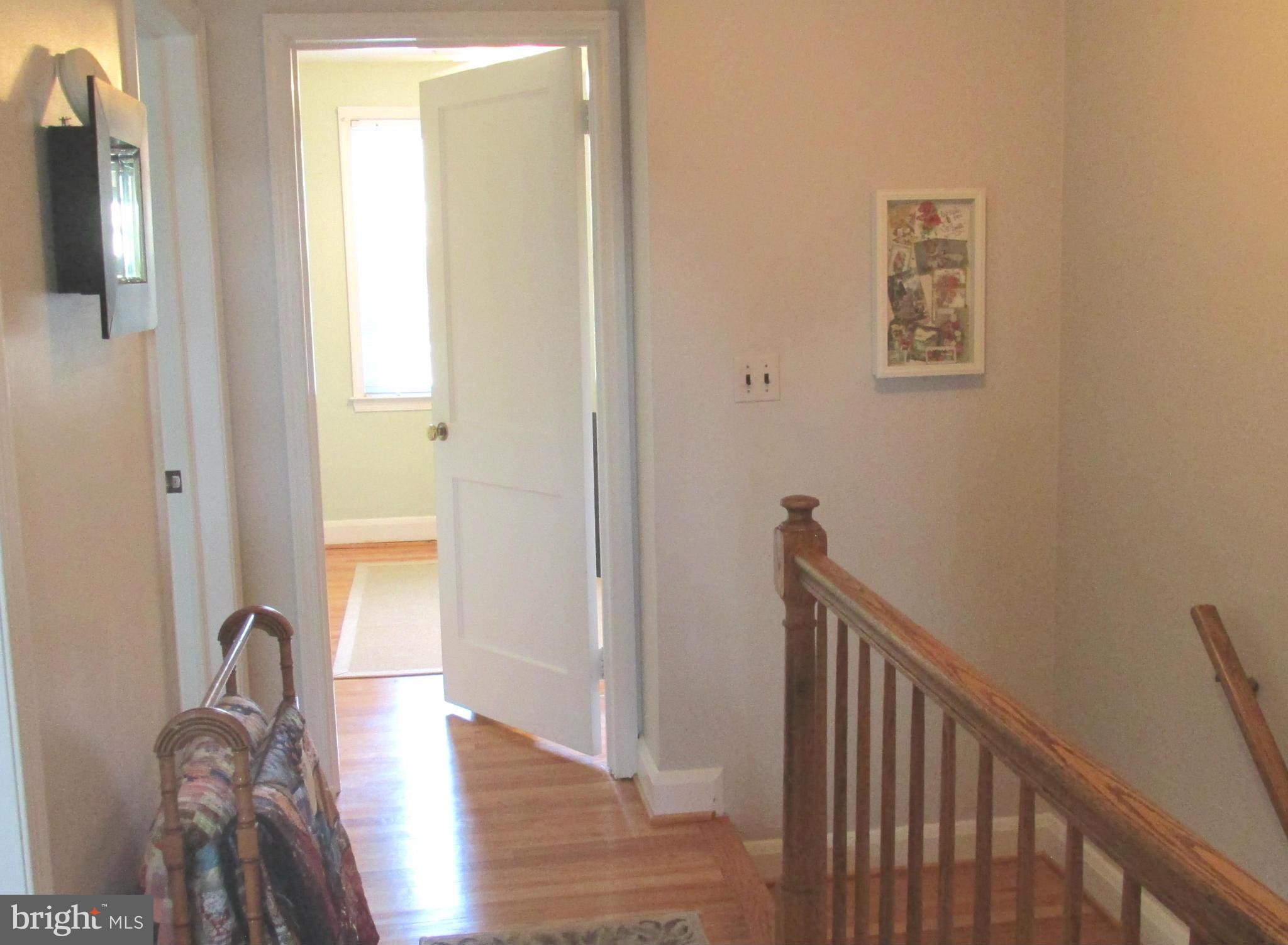 1512 Doxbury Road Baltimore, MD 21286 - Photo 11 of 24 a view of a hallway with wooden floor and a bathroom