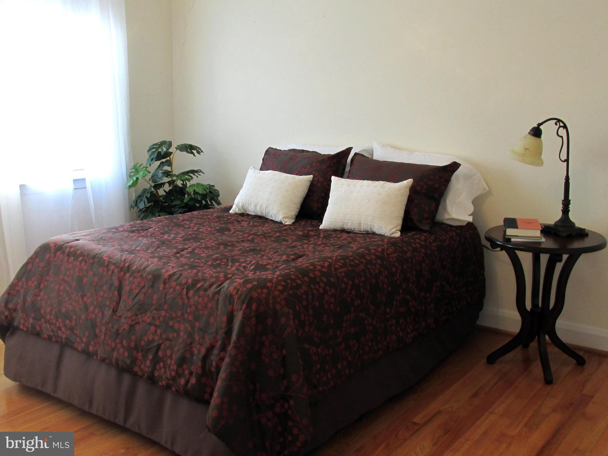 1512 Doxbury Road Baltimore, MD 21286 - Photo 12 of 24 a bedroom with a bed and wooden floor