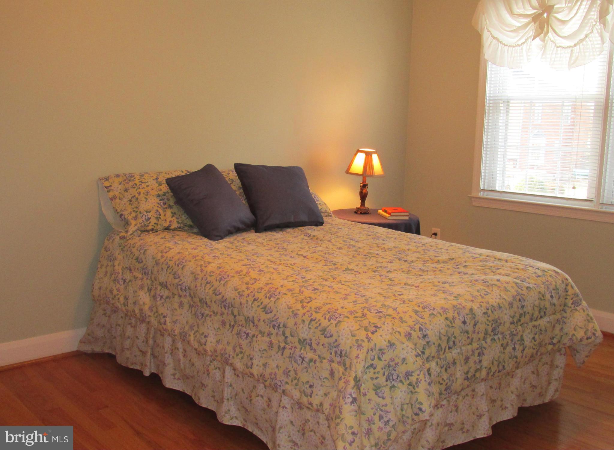 1512 Doxbury Road Baltimore, MD 21286 - Photo 13 of 24 a large bed sitting in a bedroom next to a window