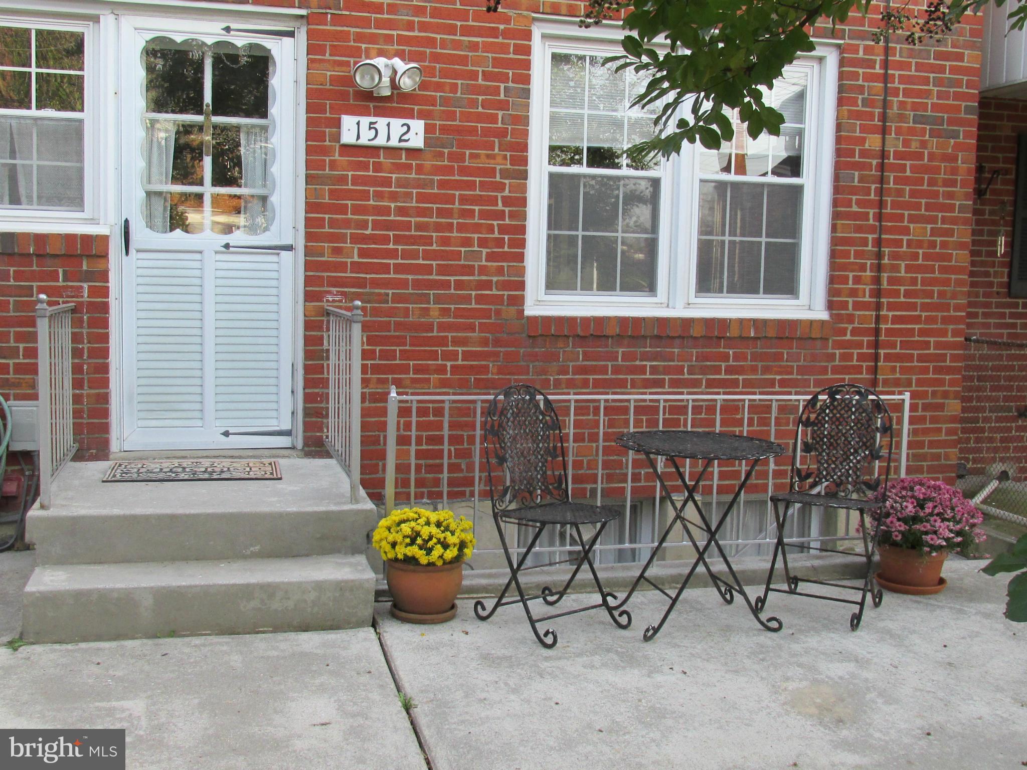 1512 Doxbury Road Baltimore, MD 21286 - Photo 19 of 24 a view of a brick house with outdoor seating space
