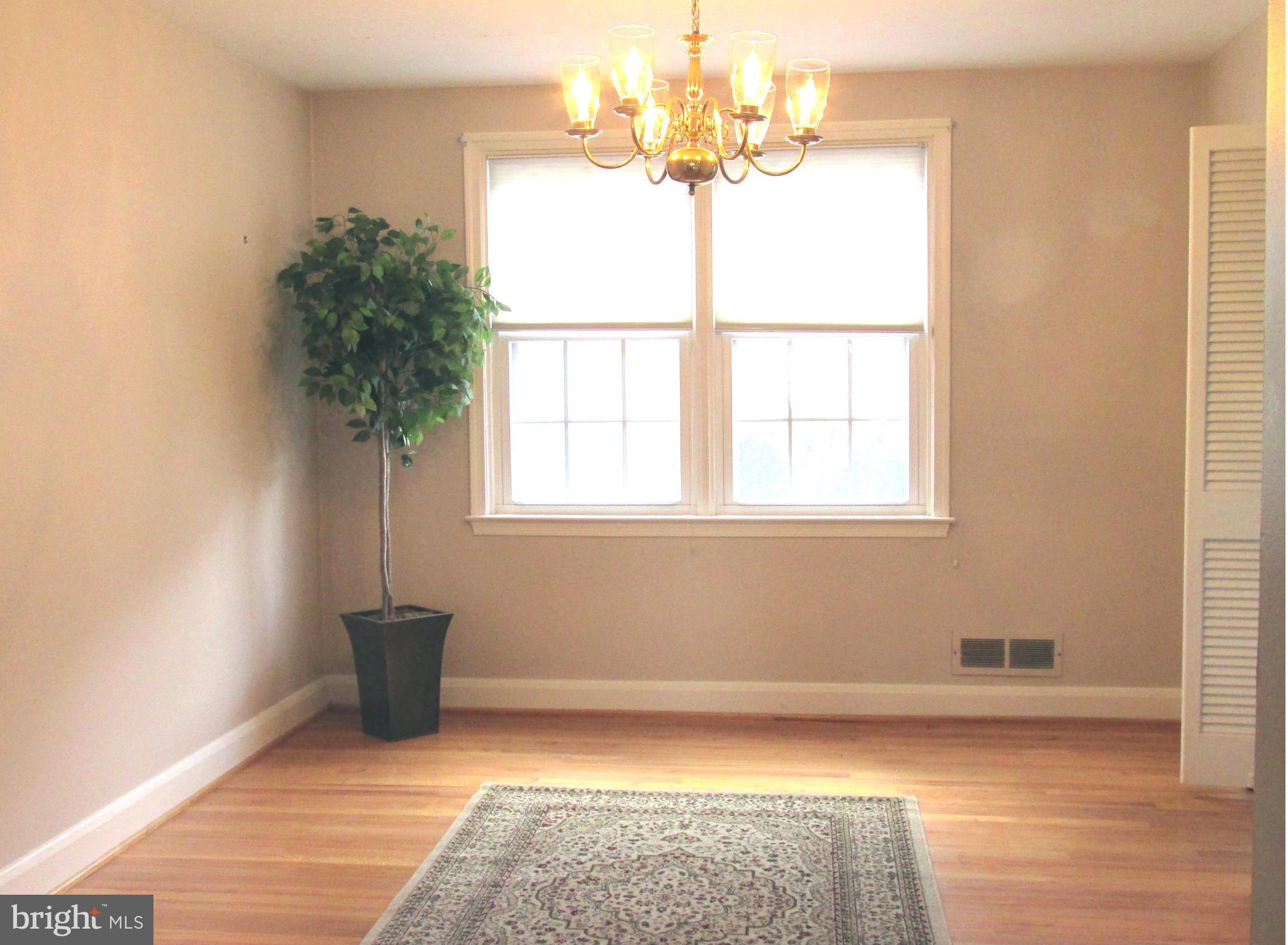 1512 Doxbury Road Baltimore, MD 21286 - Photo 6 of 24 a view of an empty room with a window and wooden floor