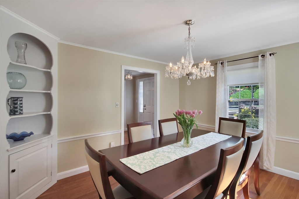 106 Channing Road Watertown, MA 02472 - Photo 12 of 39 a view of a dining room with furniture a chandelier and wooden floor