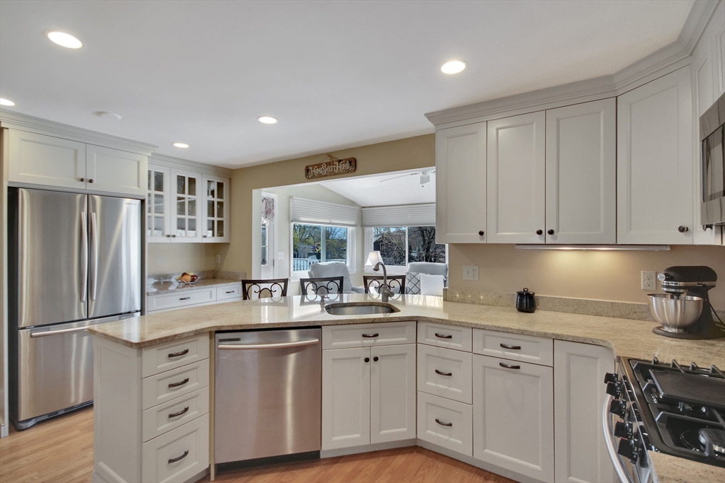 106 Channing Road Watertown, MA 02472 - Photo 2 of 39 a kitchen with white cabinets and stainless steel appliances