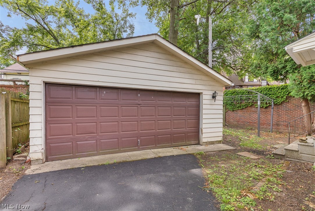 2972 Yorkshire Road Cleveland Heights, OH 44118 - Photo 39 of 44 Detached garage featuring a paneled brown garage door and exterior wall sconce