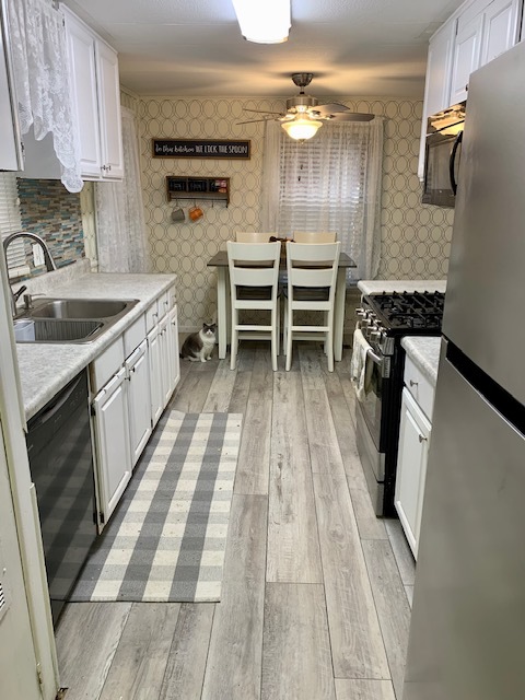1159 Lake Terrace Road Elgin, IL 60123 - Photo 6 of 14 a kitchen with a sink cabinets and stainless steel appliances